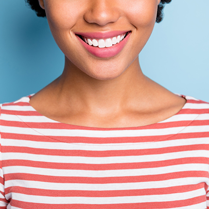 Woman smiling with bright white teeth after boutique whitening treatment